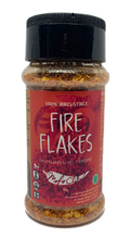Load image into Gallery viewer, Bottle of 'Fire Flakes' spice with red label and black lid on white background
